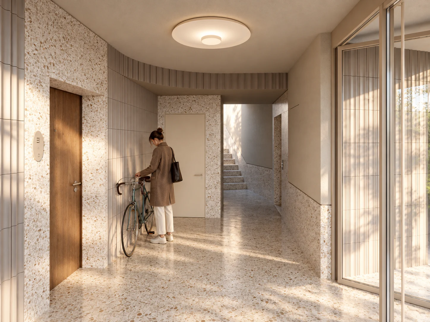 Lobby luminos, cu terrazzo, uși din lemn și acces la lift.